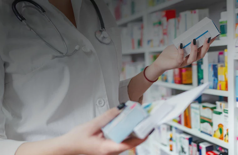 Pharmacist holding prescriptions